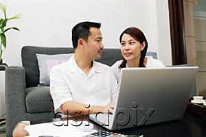 AsiaPix - Couple in living room, with laptop