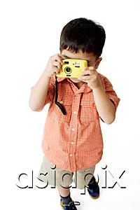 AsiaPix - Boy standing and looking through camera