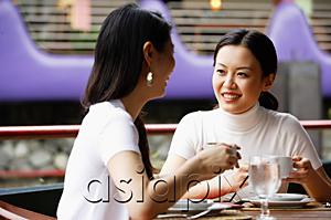 AsiaPix - Women in cafe, drinks in hand, sitting at table