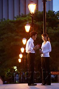 AsiaPix - Couple standing face to face, under streetlights