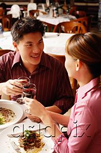 AsiaPix - Couple in restaurant, toasting with drinks