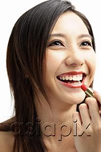 AsiaPix - Woman smiling, putting on lipstick