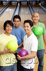 AsiaPix - Men in bowling alley, holding bowling balls, looking at camera