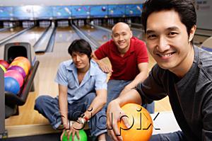 AsiaPix - Three men in bowling alley, smiling at camera