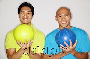 AsiaPix - Two men standing side by side, carrying bowling balls, smiling at camera