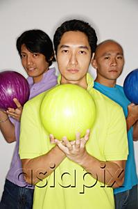AsiaPix - Three men standing carrying bowling balls, looking at camera