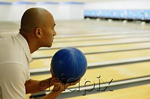AsiaPix - Man holding bowling ball, preparing to bowl