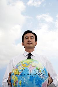 AsiaPix - Businessman standing and holding globe
