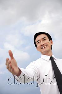 AsiaPix - Businessman with hand outstretched, smiling