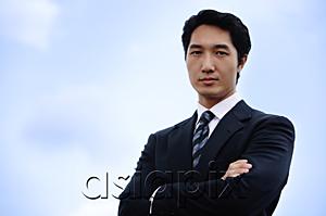 AsiaPix - Businessman with arms crossed, looking at camera