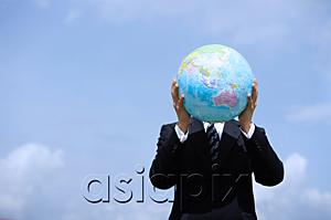 AsiaPix - Businessman holding globe, covering his face