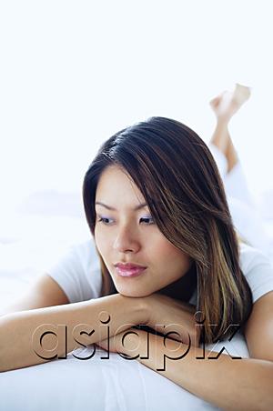 AsiaPix - Woman looking away, lying on front, arms crossed