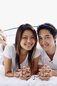 AsiaPix - Couple on bed, smiling at camera