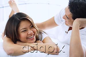 AsiaPix - Couple on bed, smiling