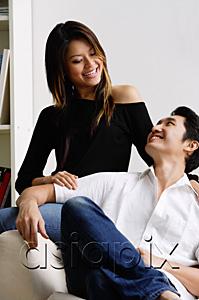 AsiaPix - Couple in living room, smiling at each other