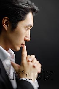 AsiaPix - Man with clasped hands, fingers on mouth