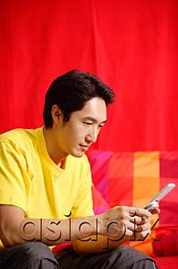 AsiaPix - Man using mobile phone, text messaging