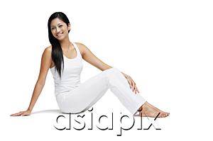 AsiaPix - Woman sitting on floor, looking at camera, legs outstretched