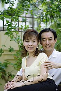 AsiaPix - Mature couple sitting on bench, woman leaning against man