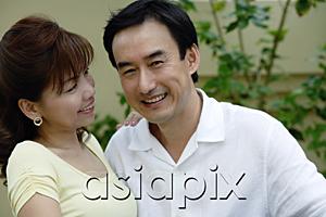 AsiaPix - Man smiling at camera, woman smiling at man