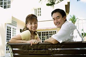 AsiaPix - Couple sitting on bench, smiling at camera