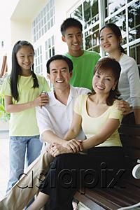 AsiaPix - Parents with three children, smiling at camera
