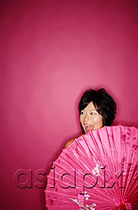 AsiaPix - Woman behind pink umbrella, against pink background