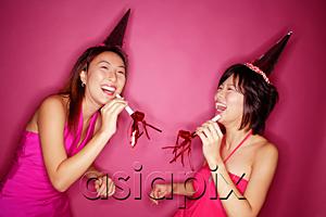 AsiaPix - Young women with noisemakers and party hats, laughing
