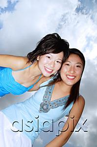 AsiaPix - Two women smiling at camera, low angle view