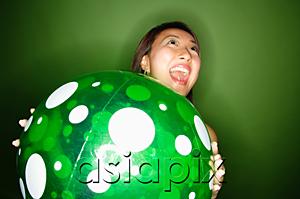 AsiaPix - Woman holding inflatable ball, mouth open