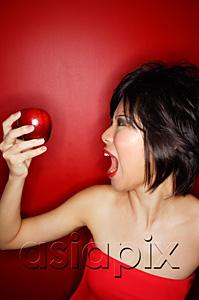 AsiaPix - Woman in red tube tope holding red apple, mouth open