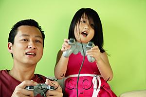 AsiaPix - Father and daughter, side by side, playing video games