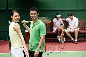 AsiaPix - Couple at tennis court, looking at camera, smiling