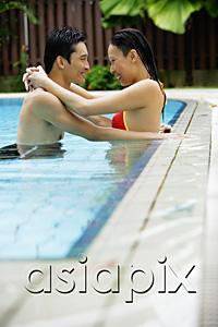 AsiaPix - Couple in swimming pool, embracing
