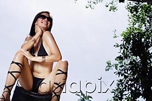 AsiaPix - Woman in bikini, sitting, legs apart, hand on neck