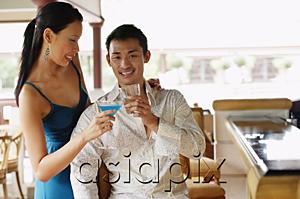AsiaPix - Couple toasting with drinks, man looking at camera