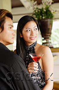 AsiaPix - Well dressed couple, looking away, woman holding a drink