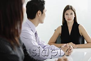 AsiaPix - Businesswoman at head of table, executives looking at her