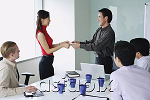 AsiaPix - Executives exchanging business cards in meeting room