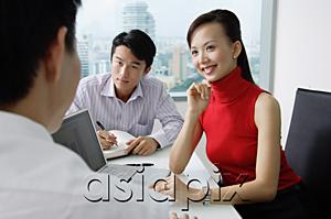 AsiaPix - Executives having a discussion, woman smiling