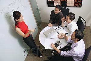AsiaPix - Executives in meeting room, female executive standing, talking