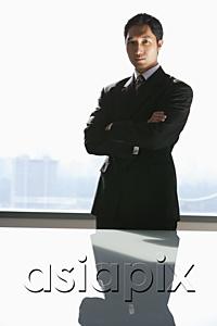 AsiaPix - Businessman standing with arms crossed, looking at camera
