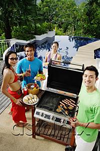 AsiaPix - Couples having a barbeque, looking at camera