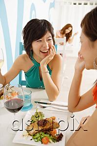 AsiaPix - Young women talking over lunch in cafe
