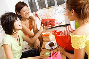 AsiaPix - Young women at home, celebrating birthday, opening gifts