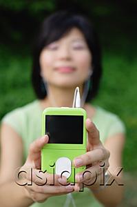 AsiaPix - Young woman with mp3 player, eyes closed