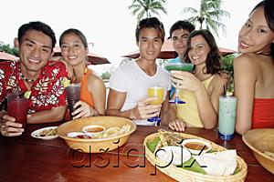 AsiaPix - Young adults having drinks at beach bar