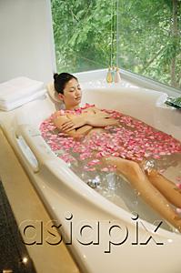 AsiaPix - Woman taking a bath, flowers floating in water
