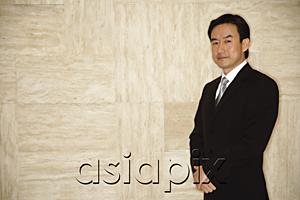AsiaPix - Businessman standing, looking at camera
