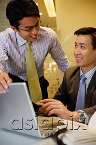 AsiaPix - Businessmen working together, using laptop